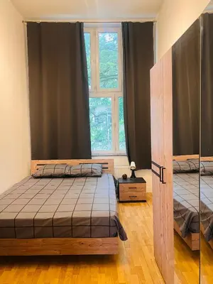 a bedroom with two beds and a window at Quarto da Nessa próximo a Louise in Brussels