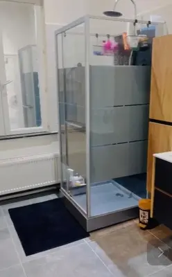 a glass refrigerator in a room with a window at Quarto da Nessa próximo a Louise in Brussels