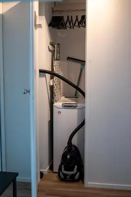 a vacuum cleaner is sitting in a closet at Studio avec vue panoramique et parking gratuit in Brussels