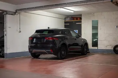 a black car parked in a parking garage at Studio avec vue panoramique et parking gratuit in Brussels