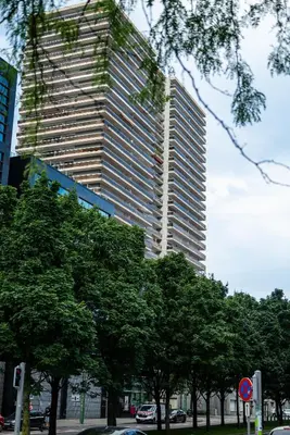 a tall building with trees in front of it at Studio avec vue panoramique et parking gratuit in Brussels