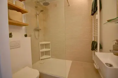 a bathroom with a shower with a toilet and a sink at Studio avec vue panoramique et parking gratuit in Brussels