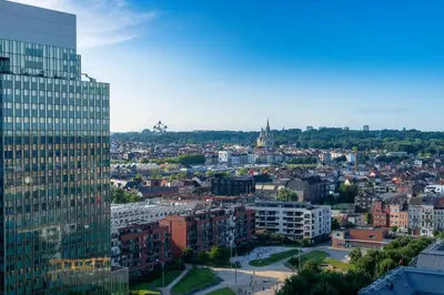 a view of a city with a tall building at Studio avec vue panoramique et parking gratuit in Brussels
