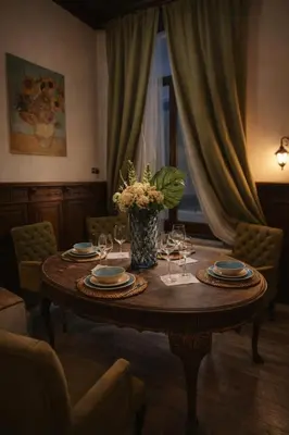 a dining room table with glasses and a vase of flowers at Magical double bedroom duplex in Brussels