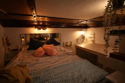a bedroom with a bed with pillows on it at Magical double bedroom duplex in Brussels