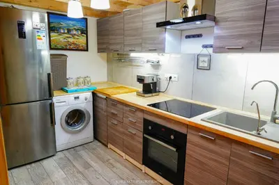 a kitchen with a washing machine and a sink at Magical double bedroom duplex in Brussels