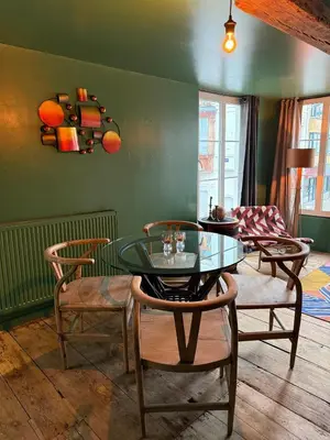 a living room with a glass table and chairs at RR Suite in Antwerp