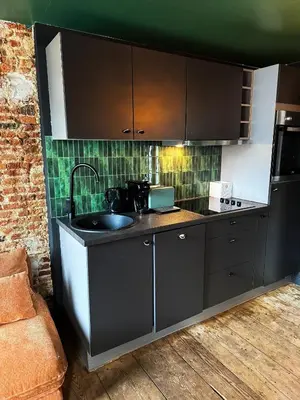 a kitchen with a sink and a counter top at RR Suite in Antwerp