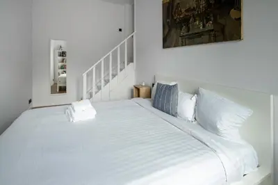 a large white bed in a white bedroom at Brussels Toison D'or residence in Brussels