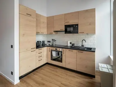 a kitchen with wooden cabinets and a sink at Brussels Toison D'or residence in Brussels