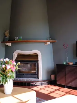 a living room with a fireplace with a shelf at Art-deco woning Gent in Ghent