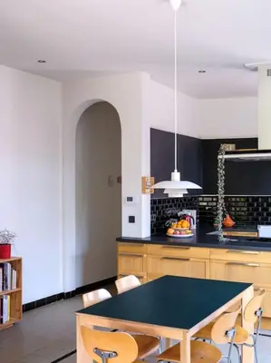 a kitchen with a table and chairs in it at Art-deco woning Gent in Ghent