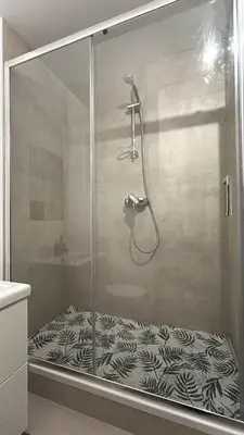 a shower with a glass door in a bathroom at Chez soi in Brussels
