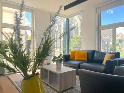a living room with a blue couch and a table at Apartment in the Heart of Ghent with Fantastic Views in Ghent