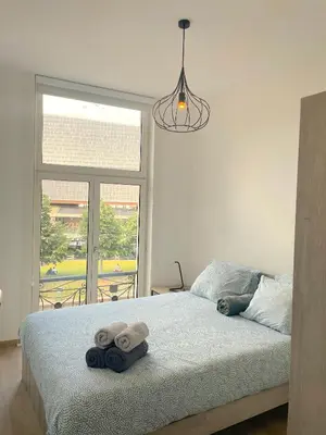 a bedroom with a bed with towels on it at Apartment in the Heart of Ghent with Fantastic Views in Ghent