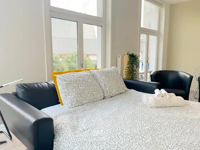a bedroom with a bed with a stuffed animal on it at Apartment in the Heart of Ghent with Fantastic Views in Ghent