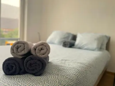 a pile of towels sitting on top of a bed at Apartment in the Heart of Ghent with Fantastic Views in Ghent