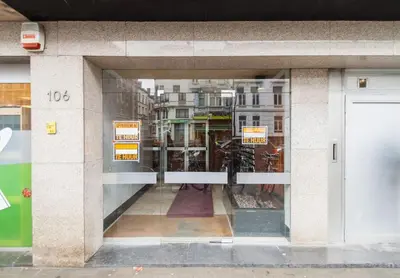 a window of a building with signs in it at Close to central station antwerp in Antwerp