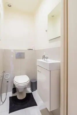 a white bathroom with a toilet and a sink at Close to central station antwerp in Antwerp