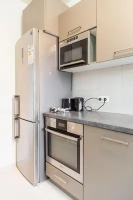 a kitchen with a stainless steel refrigerator and microwave at Close to central station antwerp in Antwerp