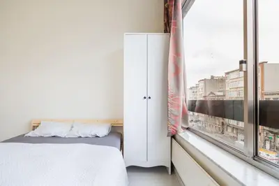 a bedroom with a bed and a window at Close to central station antwerp in Antwerp