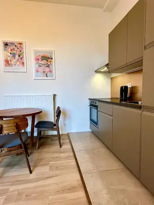 a kitchen with a table and a dining room table at Luxury Suits Royal by Rikas Hotels in Antwerp