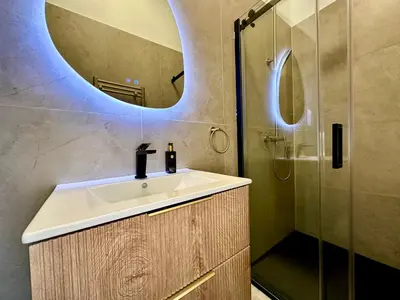 a bathroom with a sink and a shower at Luxury Suits Royal by Rikas Hotels in Antwerp