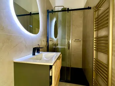 a bathroom with a sink and a shower at Luxury Suits Royal by Rikas Hotels in Antwerp
