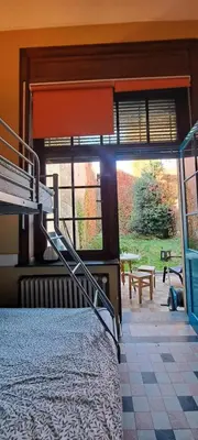 a bedroom with a bunk bed and a large window at Smallfunnyworld Brussels in Brussels