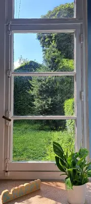 a window with a view of a green field at Smallfunnyworld Brussels in Brussels
