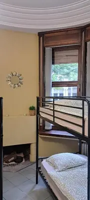 a bedroom with two bunk beds and a window at Smallfunnyworld Brussels in Brussels