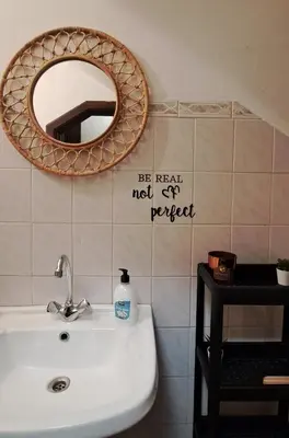 a bathroom with a sink and a mirror on the wall at Smallfunnyworld Brussels in Brussels