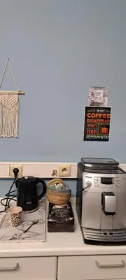 a kitchen counter with a toaster oven and a basket on it at Smallfunnyworld Brussels in Brussels