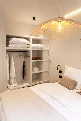 a bedroom with a white bed and a chandelier at Perfect-Stay in Antwerp
