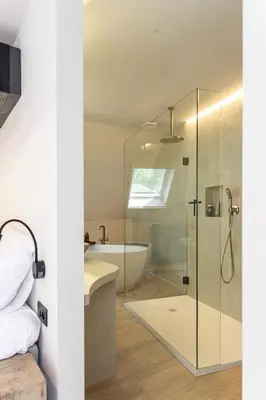 a bathroom with a glass shower and a bath tub at Perfect-Stay in Antwerp