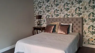 a bed with two pillows on it in a bedroom at Holiday in de kempen in Turnhout