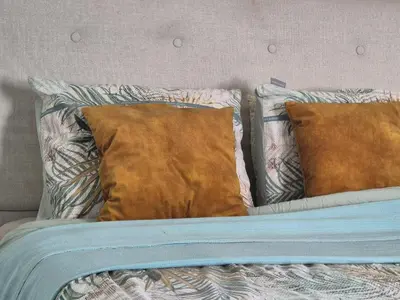 a bed with two pillows on top of it at Holiday in de kempen in Turnhout