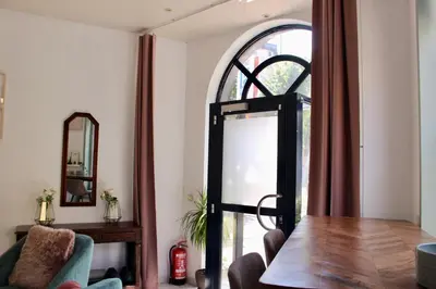 a dining room with a table and a glass door at Cozy private suite in Ghent