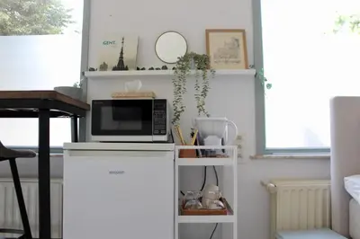 a kitchen with a microwave on top of a counter at Cozy private suite in Ghent