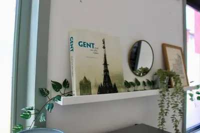 a book sitting on top of a shelf at Cozy private suite in Ghent