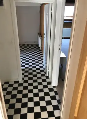 a hallway with a black and white checkered floor at Cosy place near Atomium with parking in Vilvoorde