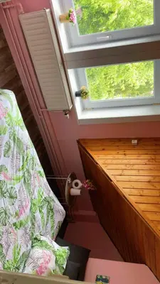 a attic room with a bed and a window at Cosy place near Atomium with parking in Vilvoorde