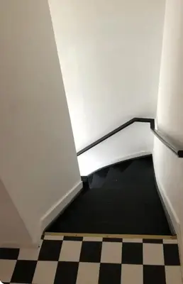 a hallway with a black and white checkered floor at Cosy place near Atomium with parking in Vilvoorde