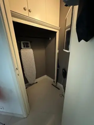 a walk in closet with a chair in a room at Appartement Ixelles 2 chambres, 3 lits in Brussels
