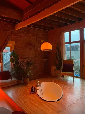a large bathroom with a bath tub on a wooden floor at t'PK in Antwerp