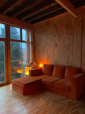 a living room with a couch and a large window at t'PK in Antwerp