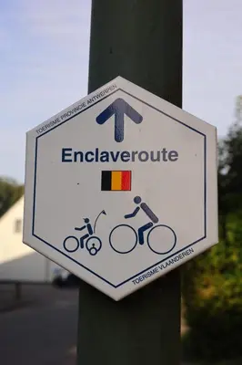 a sign on a pole with bikes on it at De Baolse Herberg in Baarle-Hertog