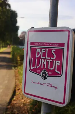 a sign for a bemis lite on a pole at De Baolse Herberg in Baarle-Hertog