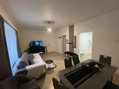 a living room with a couch and a table at E&L Appartement in Willebroek