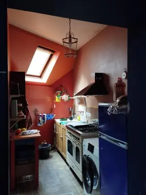 a kitchen with a stove and a blue refrigerator at Artistic appartment near downtown & railwaystation in Antwerp